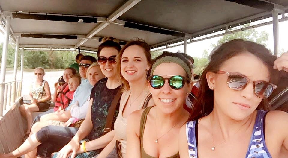 People on a boat visiting a Louisiana swamp